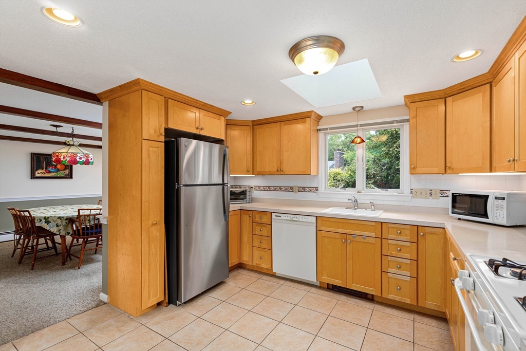 140 Rolling Hitch Road Barnstable, MA 02632 - Photo 8 of 36 a kitchen with stainless steel appliances granite countertop a refrigerator and a sink