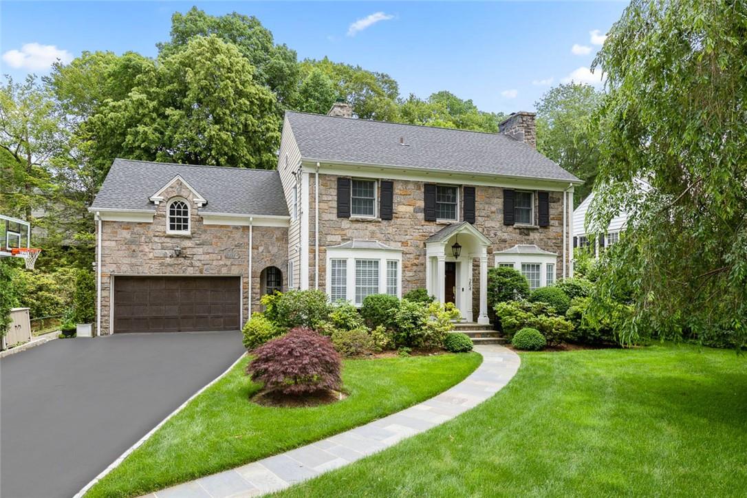 254 Fox Meadow Road Scarsdale, NY 10583 - Photo 1 of 1 a front view of a house with a garden
