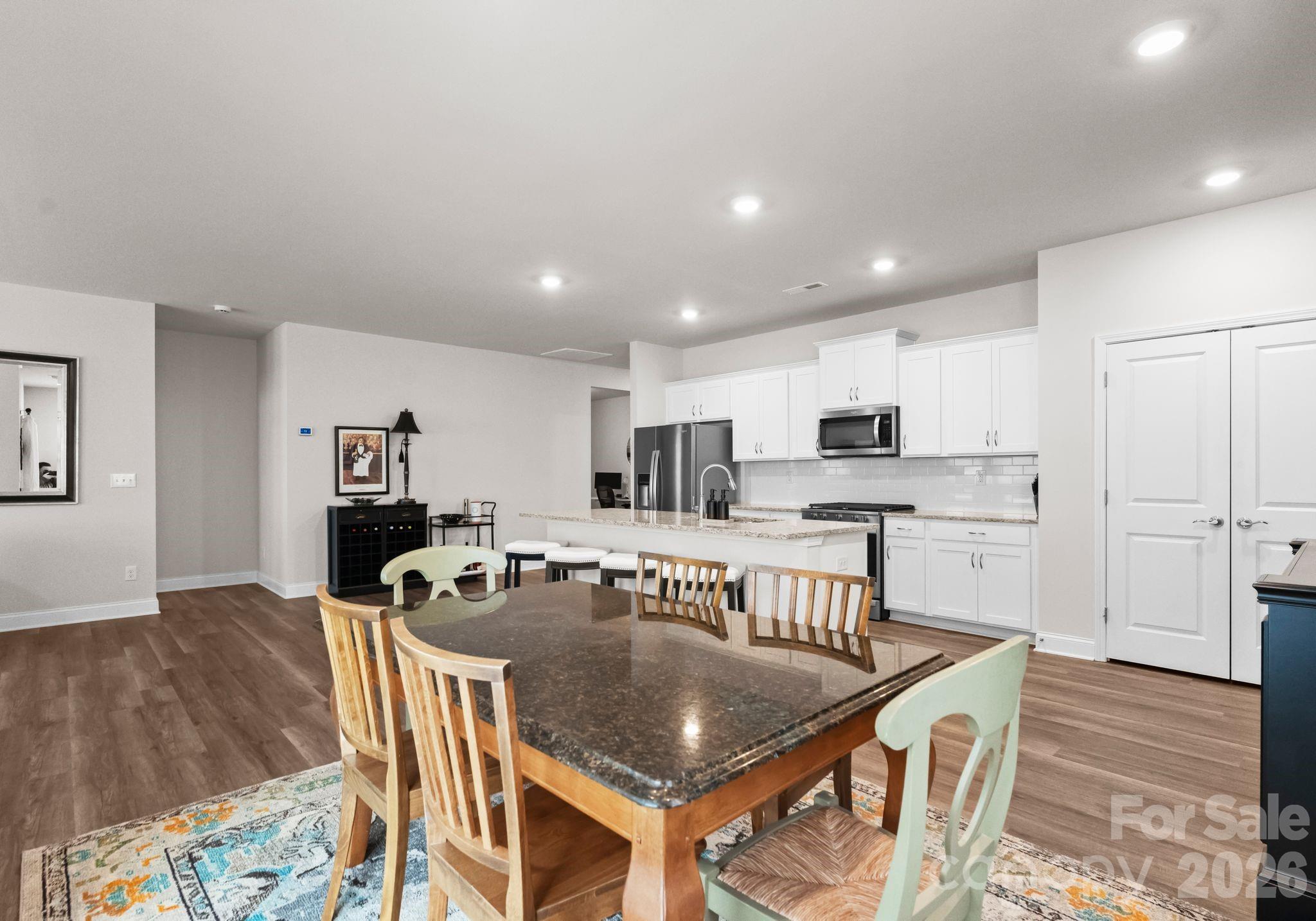 2004 Bonds Lane Fort Mill, SC 29715 - Photo 15 of 41 a kitchen with stainless steel appliances granite countertop a stove top oven a sink a dining table and chairs