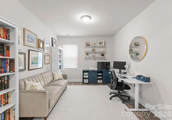 a view of a livingroom with workspace and a couch