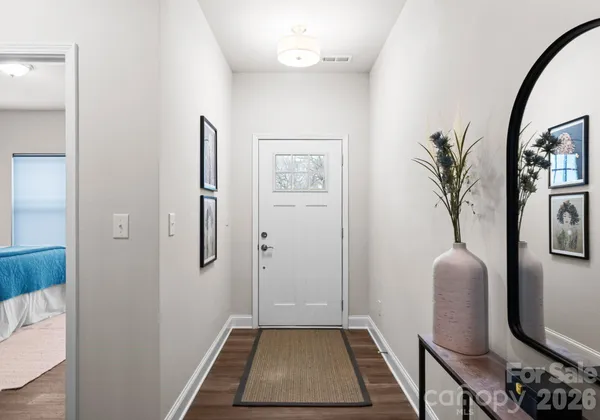 a hallway with painting and a potted plant