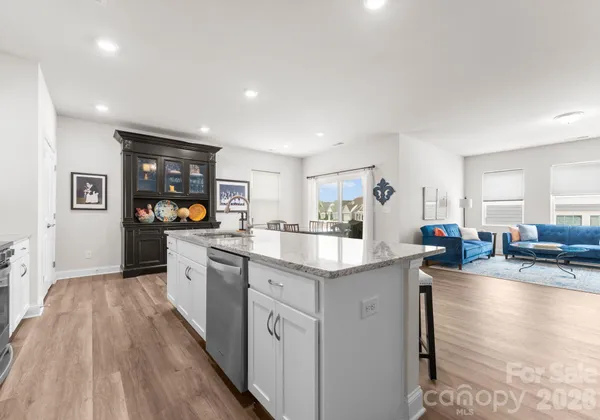 a kitchen with counter space sink stove and wooden floor
