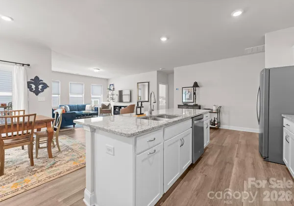 a large kitchen with lots of counter space and furniture