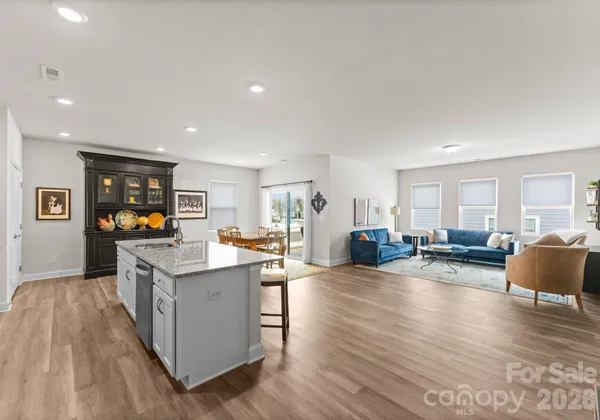 a open kitchen with sink cabinets and wooden floor