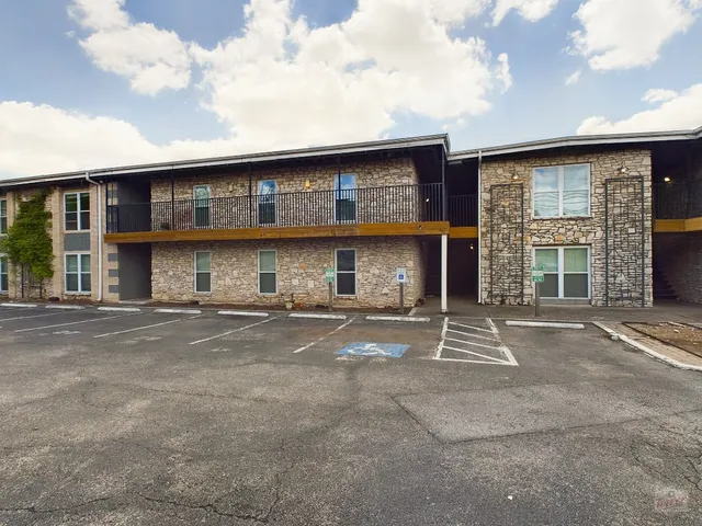 a front view of a brick house with a large window