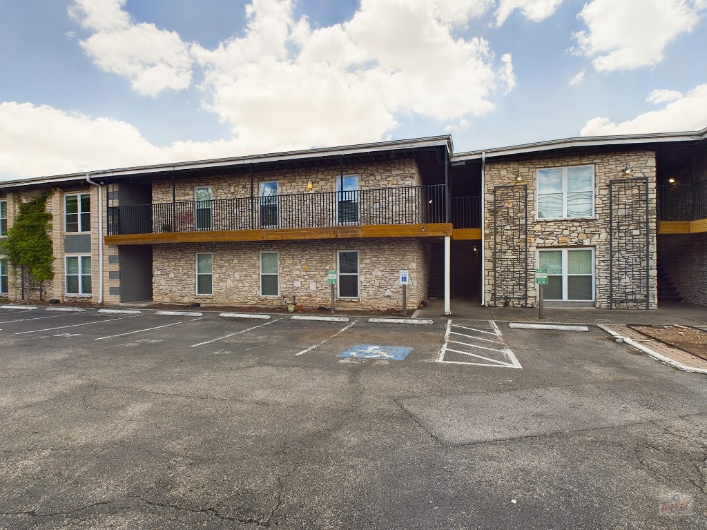 2401 Manor Road, Unit 137 Austin, TX 78722 - Photo 11 of 15 a front view of a brick house with a large window