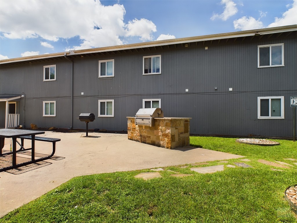 2401 Manor Road, Unit 137 Austin, TX 78722 - Photo 13 of 15 a yellow house with yard in front of it