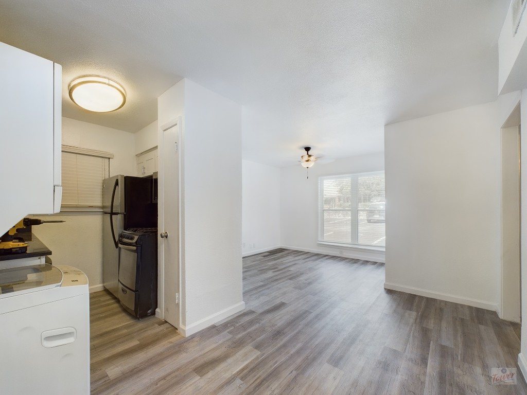 2401 Manor Road, Unit 137 Austin, TX 78722 - Photo 2 of 15 an empty room with wooden floor and windows