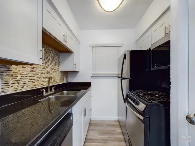 a kitchen that has a sink and a stove