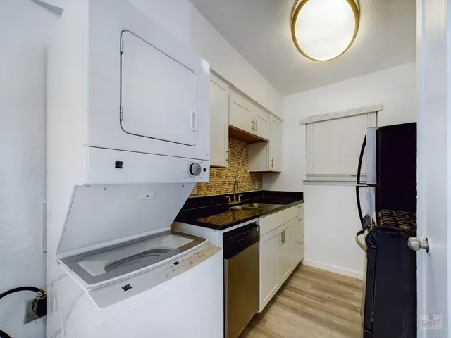 a kitchen with cabinets and a stove top oven