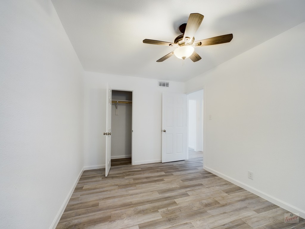 2401 Manor Road, Unit 137 Austin, TX 78722 - Photo 8 of 15 a view of an empty room with wooden floor