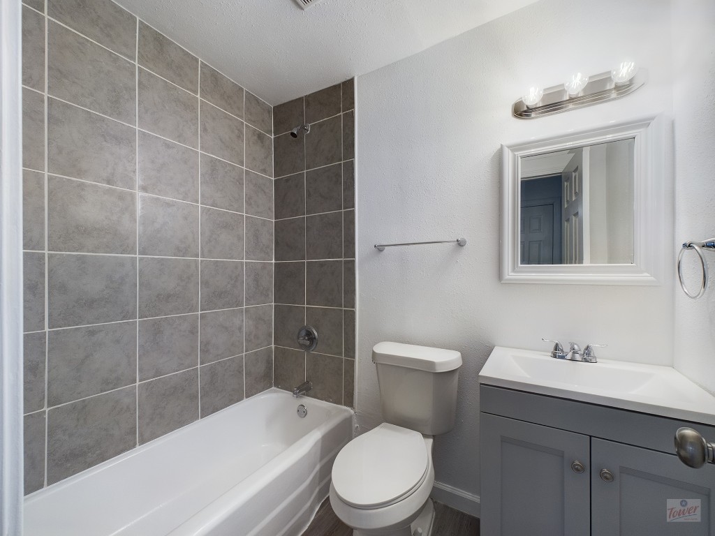 2401 Manor Road, Unit 137 Austin, TX 78722 - Photo 9 of 15 a bathroom with a sink a toilet and shower