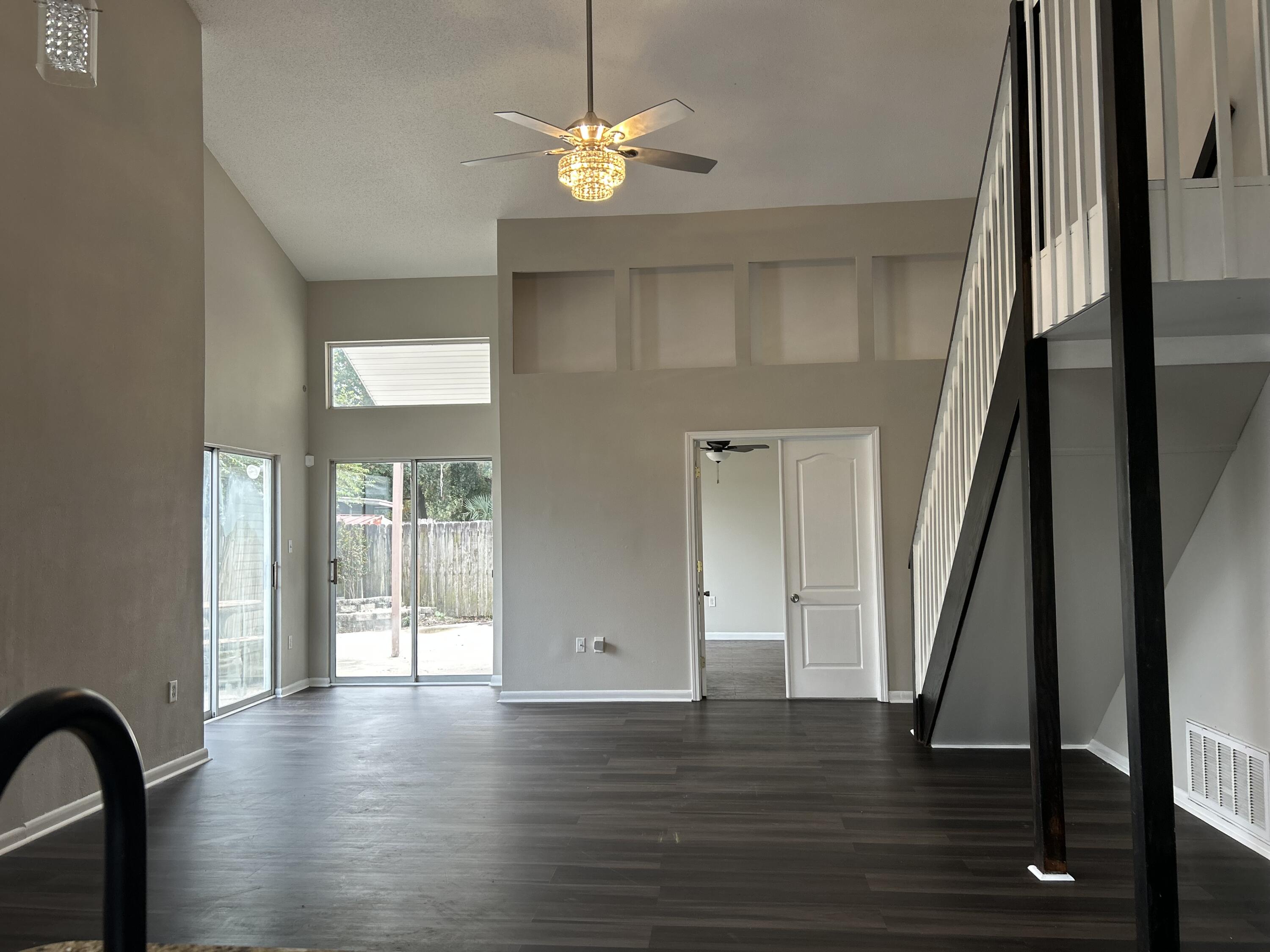 404 Adam Street Northwest Fort Walton Beach, FL 32548 - Photo 2 of 11 a view of a livingroom with wooden floor and a chandelier