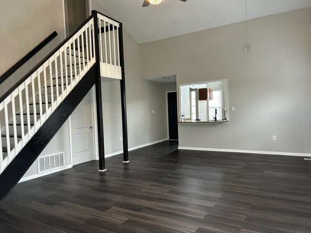 a view of an entryway with wooden floor and stairs