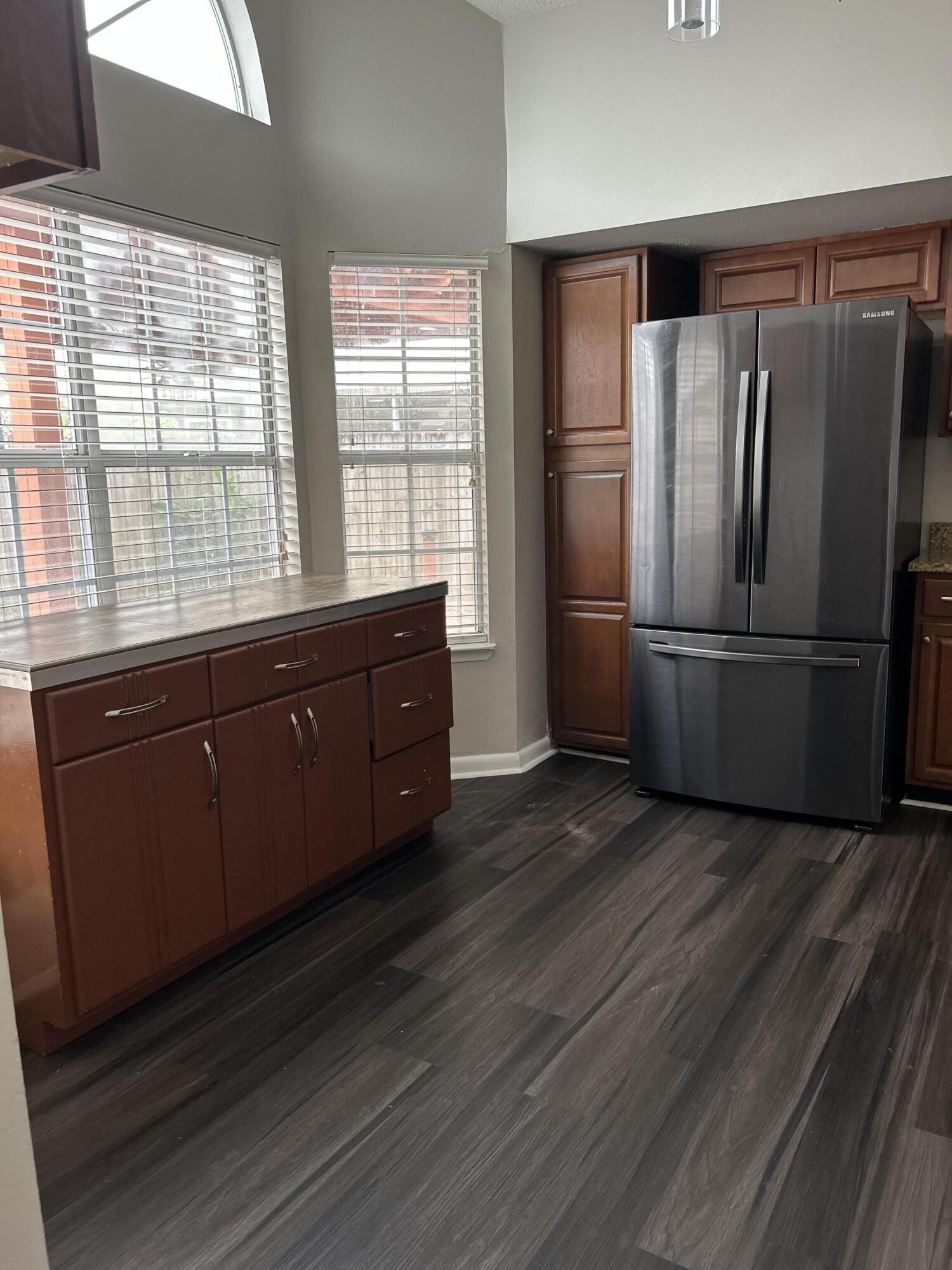 404 Adam Street Northwest Fort Walton Beach, FL 32548 - Photo 5 of 11 a kitchen with stainless steel appliances wooden floors and wooden cabinets