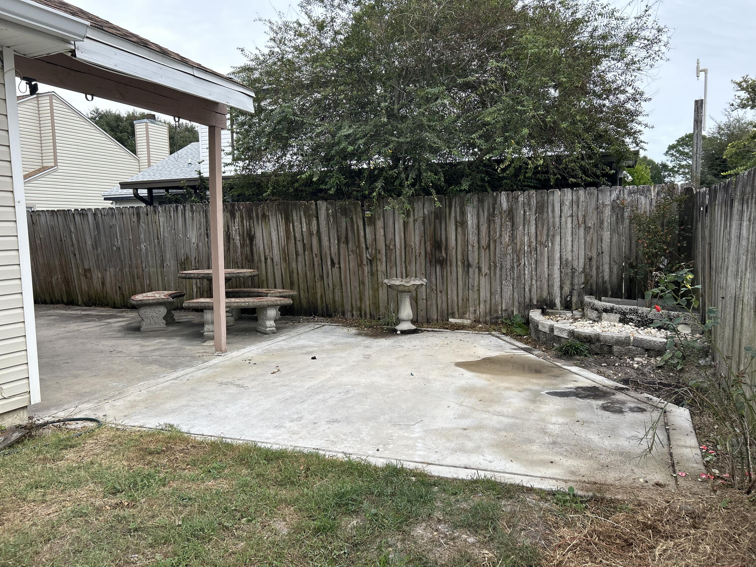 404 Adam Street Northwest Fort Walton Beach, FL 32548 - Photo 9 of 11 a backyard of a house with chairs and a table