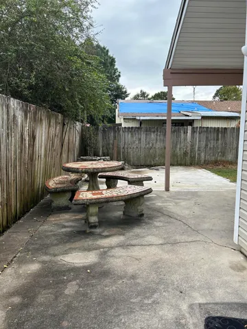 a view of a backyard with a sitting area