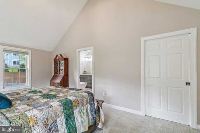 a living room with furniture stove and wooden floor