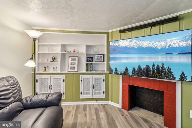 a view of a house with a yard and potted plants