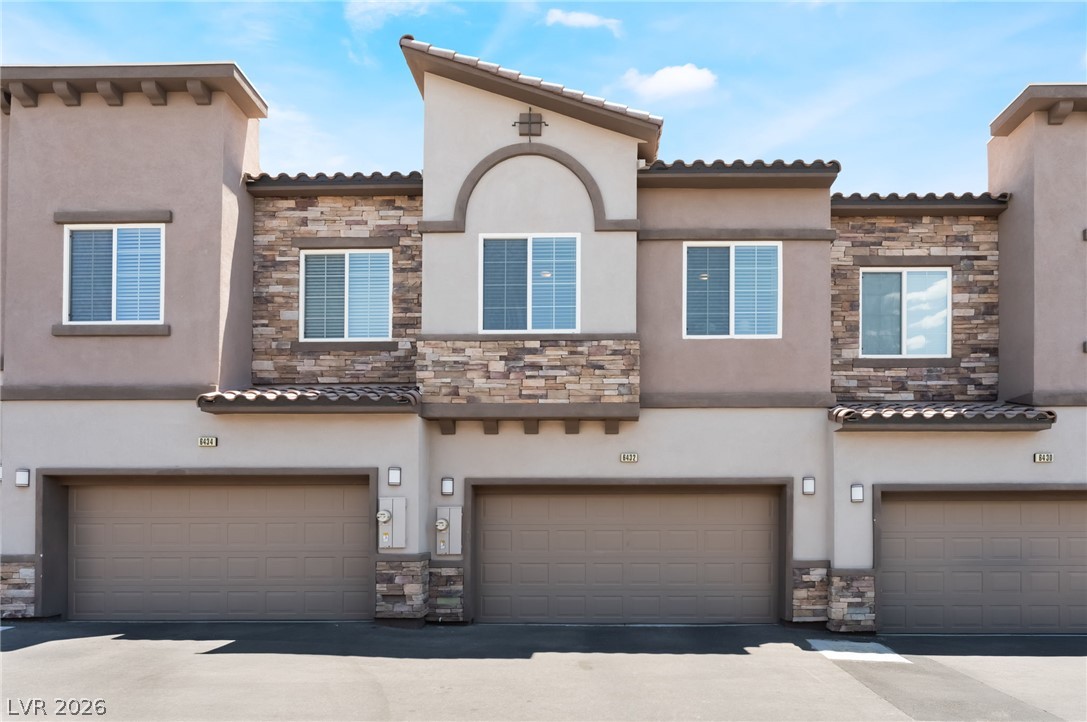 6432 Spring Jog Street Las Vegas, NV 89166 - Photo 37 of 61 Modern townhome boasts stylish stucco and stone accents, creating appealing curb presence.