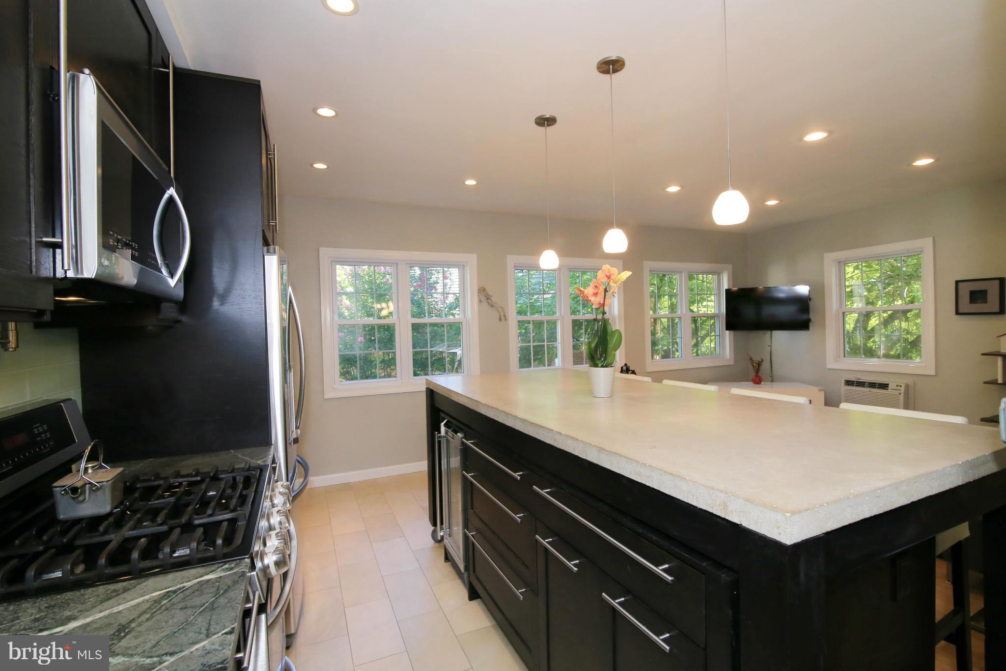 3603 Gunston Road, Unit 3603 Alexandria, VA 22302 - Photo 5 of 27 a kitchen with a sink and a stove top oven with wooden floor