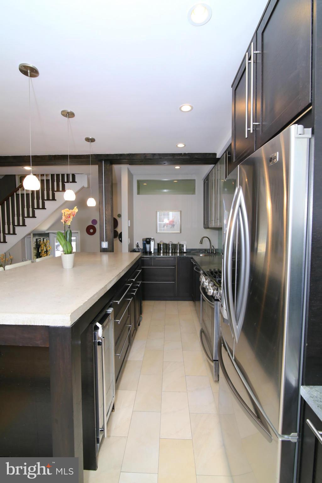 3603 Gunston Road, Unit 3603 Alexandria, VA 22302 - Photo 7 of 27 a kitchen with stainless steel appliances granite countertop a sink refrigerator and cabinets