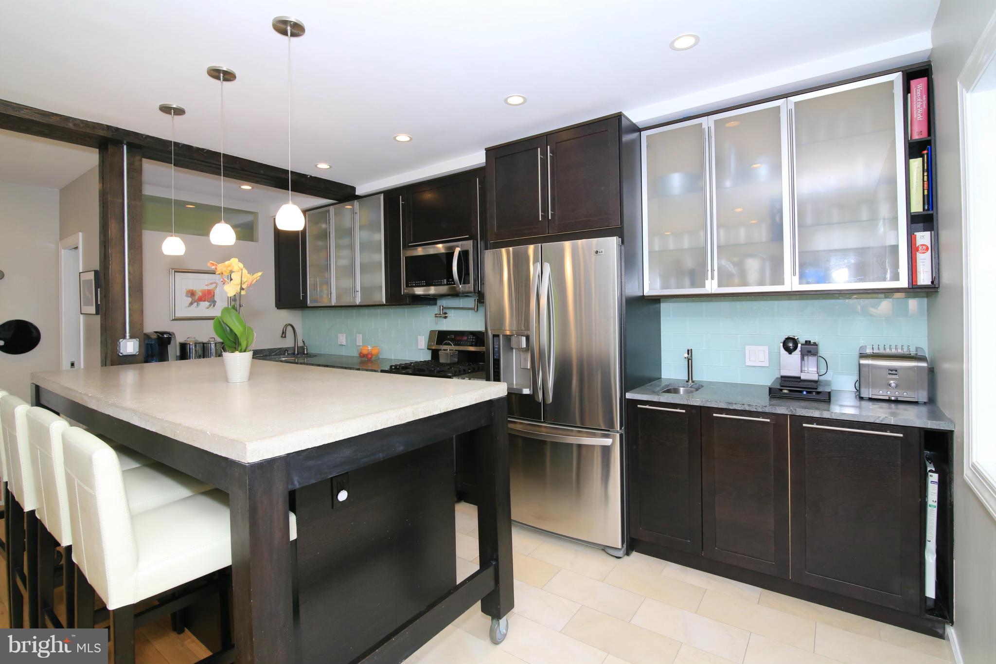 3603 Gunston Road, Unit 3603 Alexandria, VA 22302 - Photo 8 of 27 a kitchen with stainless steel appliances granite countertop a refrigerator a sink a stove and a refrigerator
