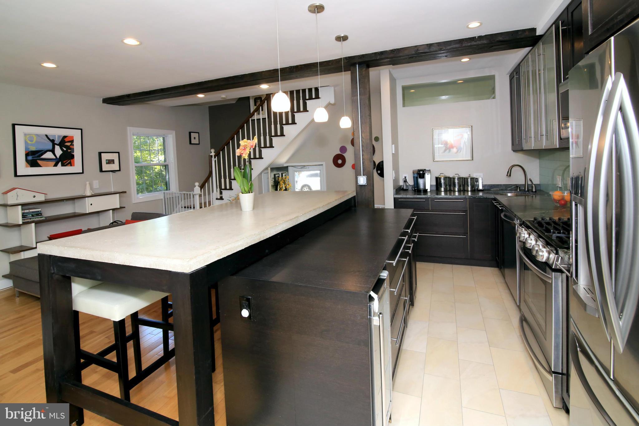 3603 Gunston Road, Unit 3603 Alexandria, VA 22302 - Photo 9 of 27 a kitchen with kitchen island a counter top space a sink stainless steel appliances and cabinets