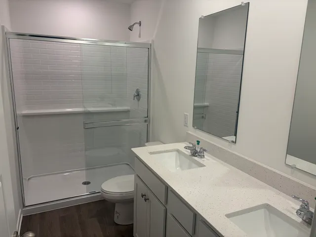 a bathroom with a sink toilet and shower