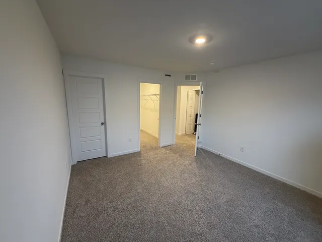 a view of an empty room and a window