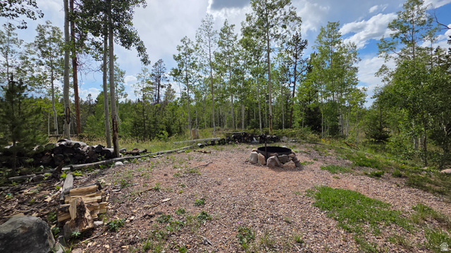 5782 Pineview Loop, Unit 921 Kamas, UT 84036 - Photo 20 of 29 Expansive natural landscape featuring a central fire pit with a stone surround