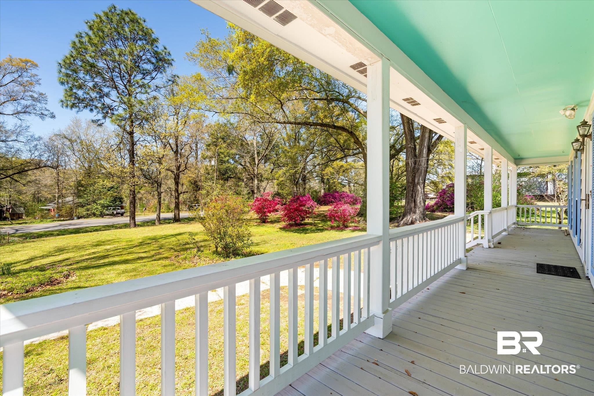 6030 Lott Road Eight Mile, AL 36613 - Photo 19 of 21 Wooden terrace featuring covered porch, a yard, and visible vents