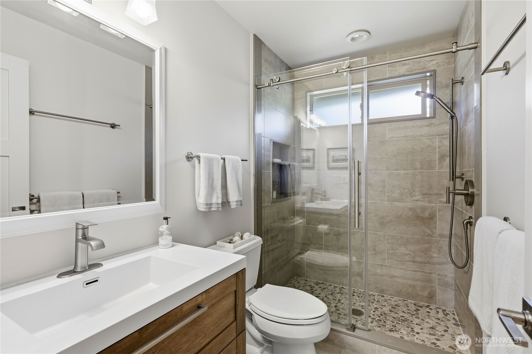 37709 Olympic View Road Northeast Hansville, WA 98340 - Photo 23 of 40 a bathroom with a sink mirror toilet and shower