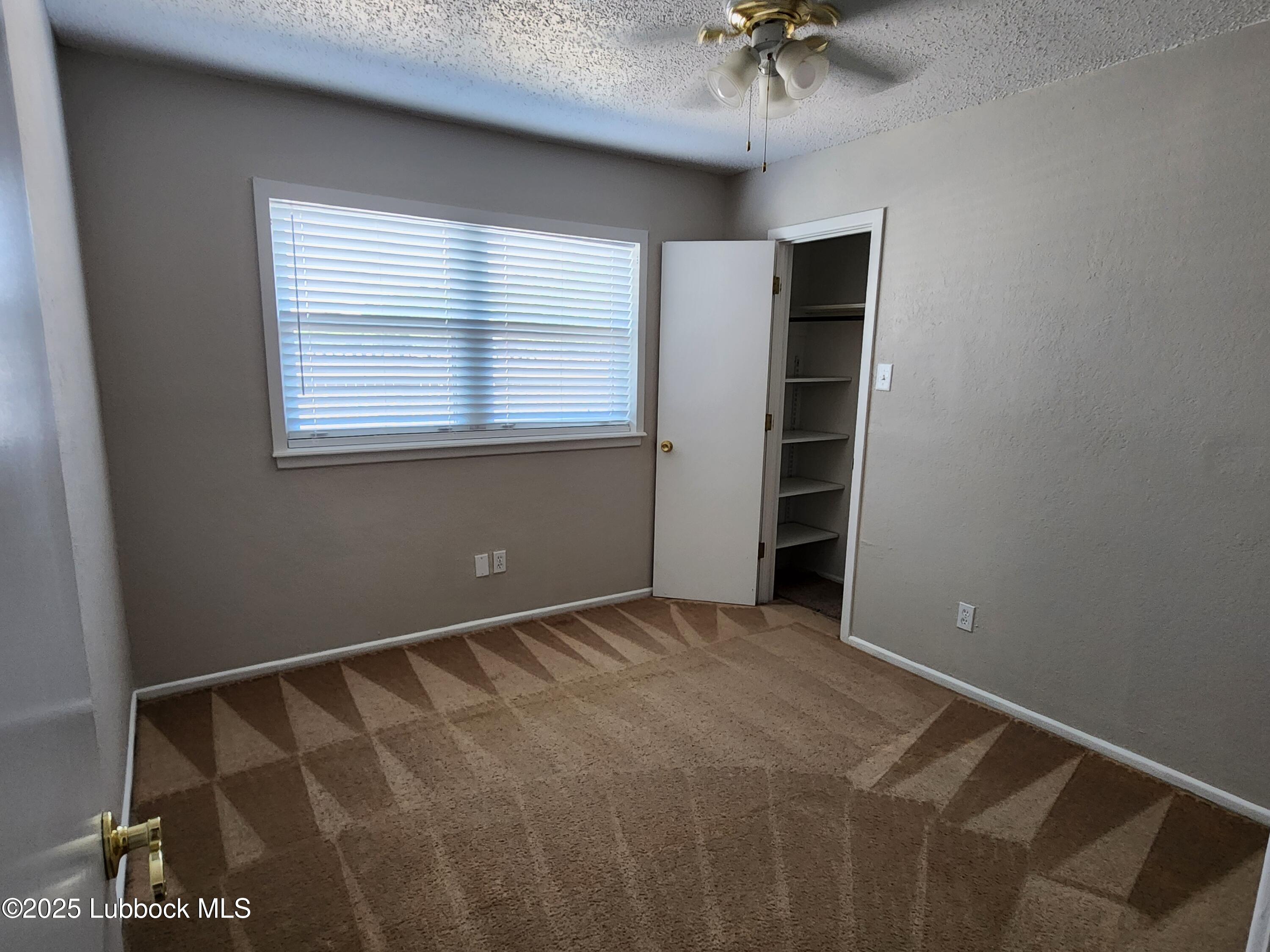5502 Amherst Street Lubbock, TX 79416 - Photo 11 of 26 a view of an empty room with a window