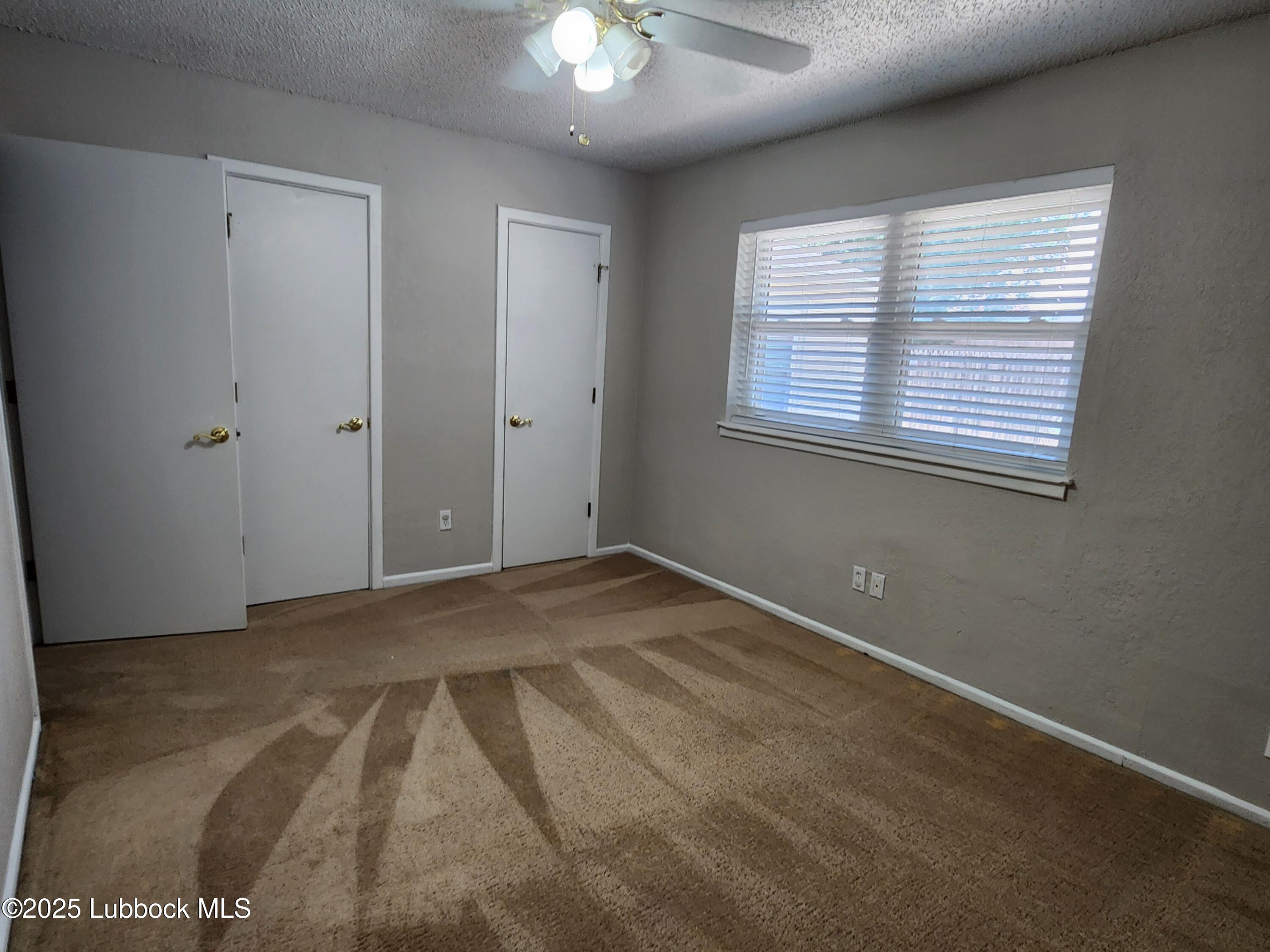 5502 Amherst Street Lubbock, TX 79416 - Photo 12 of 26 a view of an empty room with a window
