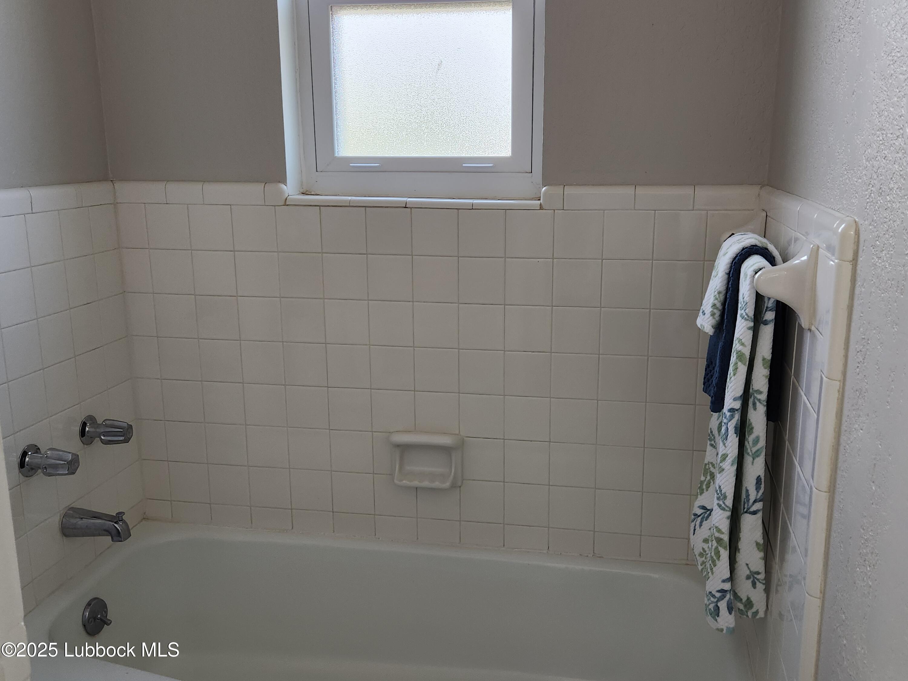 5502 Amherst Street Lubbock, TX 79416 - Photo 16 of 26 a close up of a bathtub