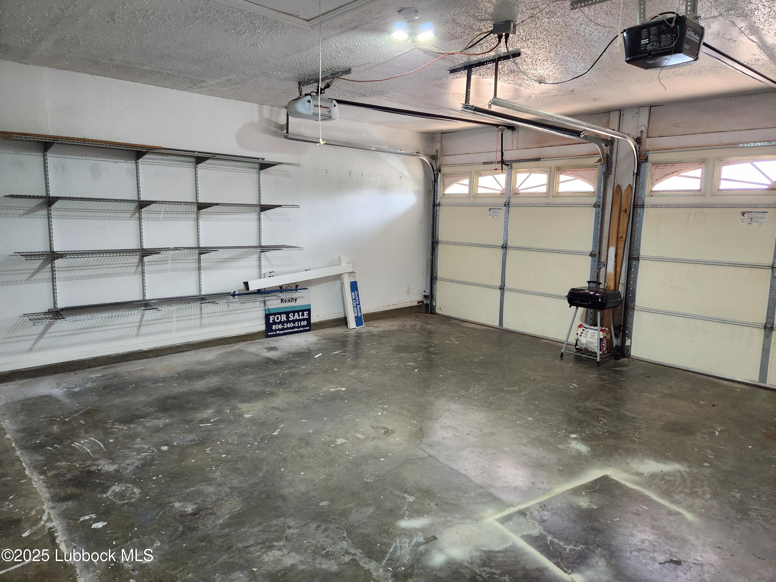 5502 Amherst Street Lubbock, TX 79416 - Photo 24 of 26 a view of a garage with wooden floor