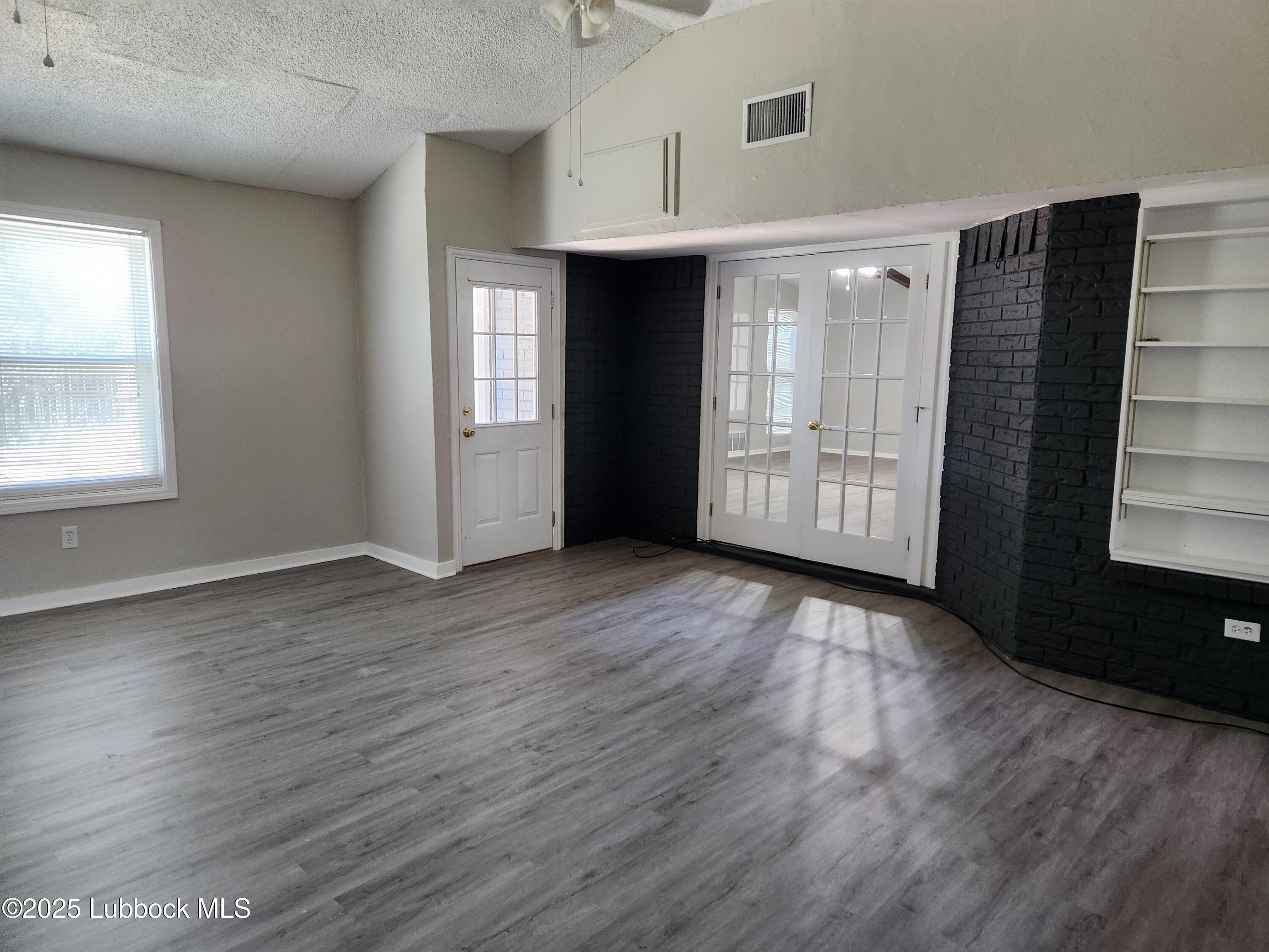5502 Amherst Street Lubbock, TX 79416 - Photo 26 of 26 an empty room with wooden floor and windows