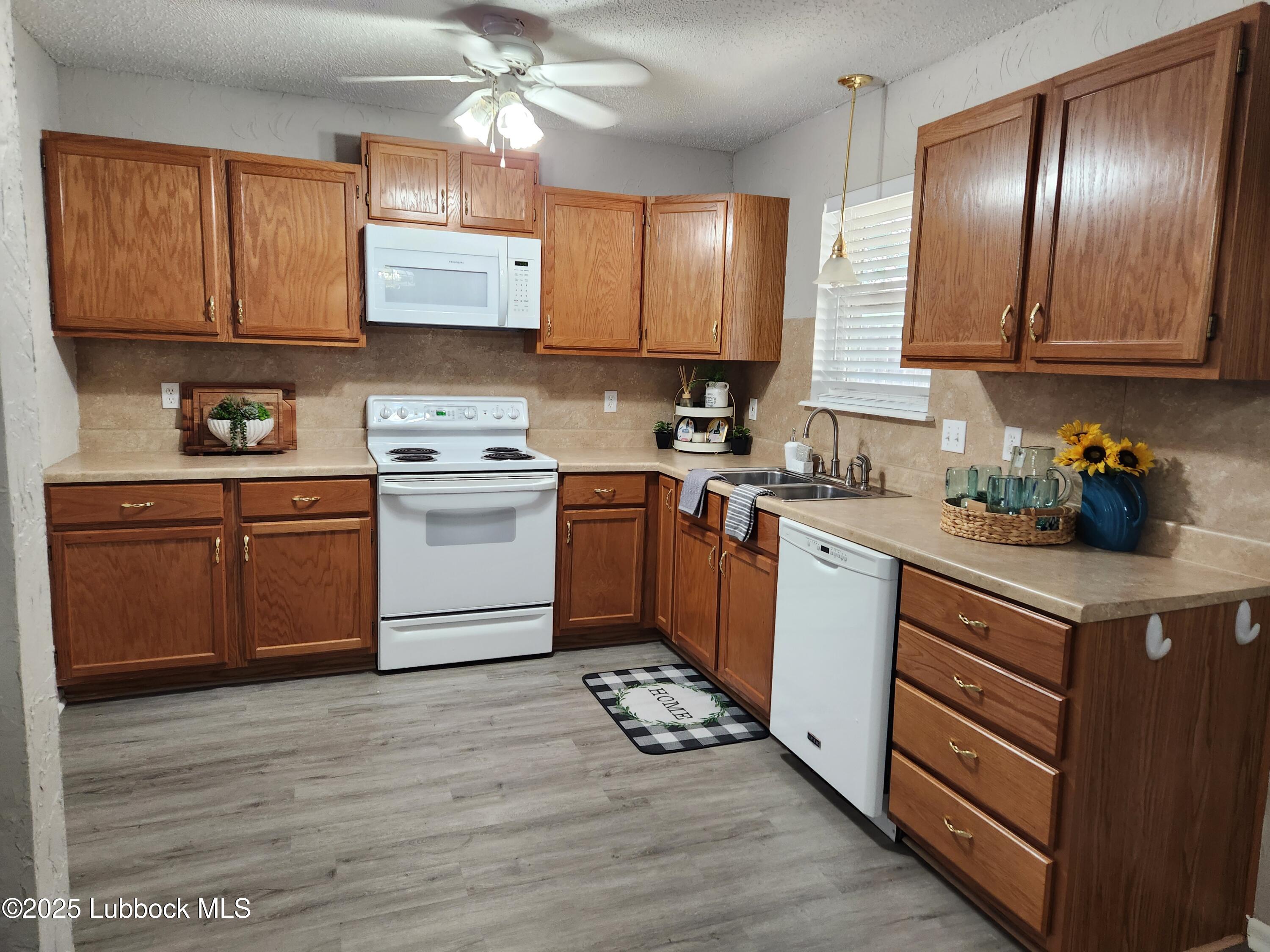 5502 Amherst Street Lubbock, TX 79416 - Photo 3 of 26 a kitchen with a sink cabinets and window