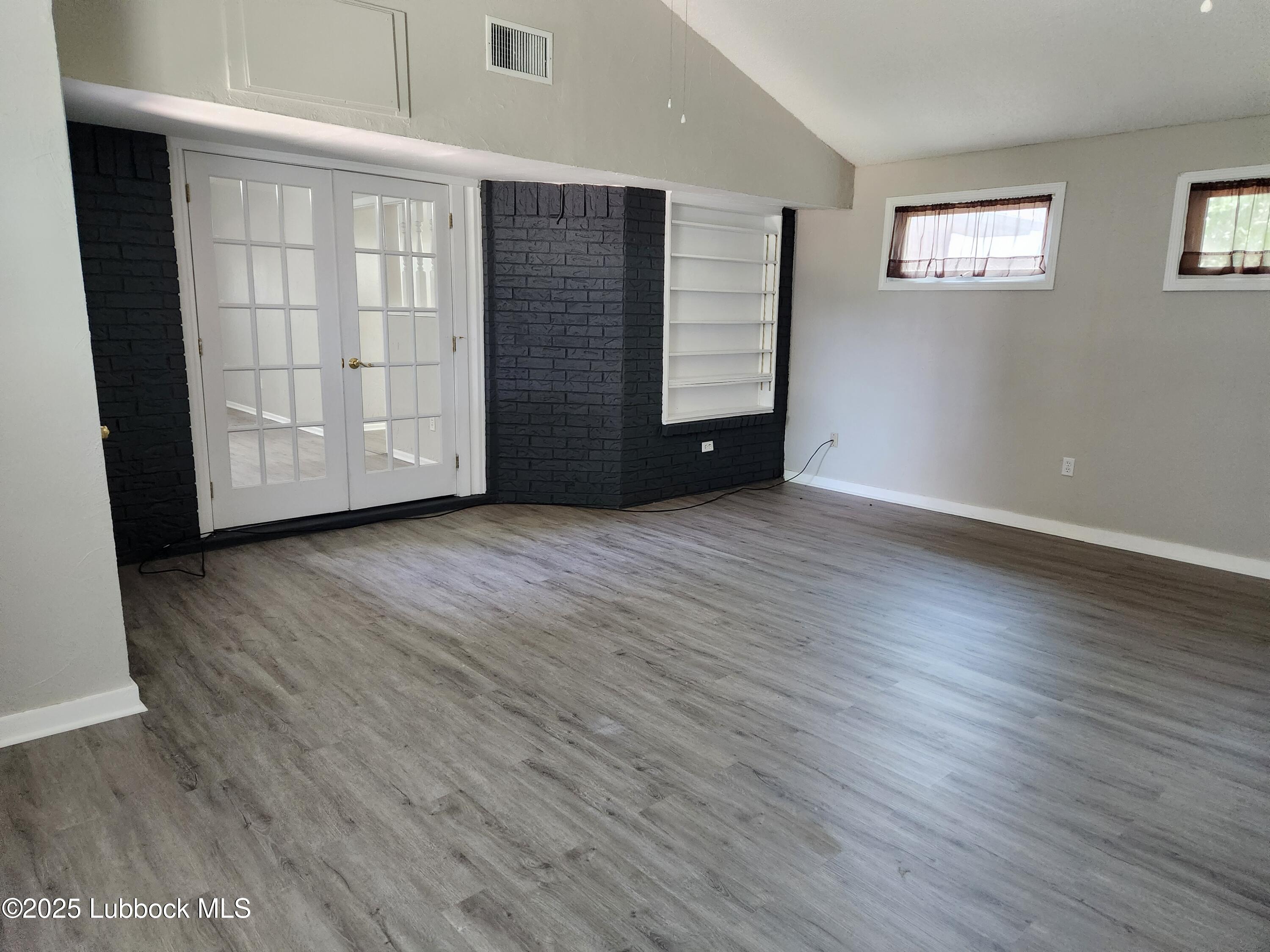 5502 Amherst Street Lubbock, TX 79416 - Photo 8 of 26 an empty room with wooden floor and closet