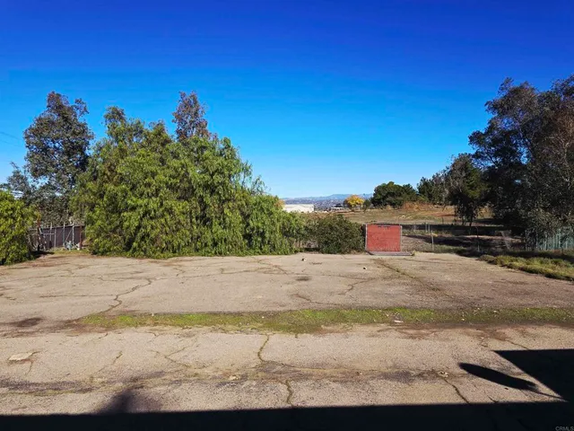 a view of a hallway with furniture and a window