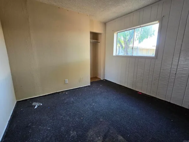 a view of backyard with wooden fence