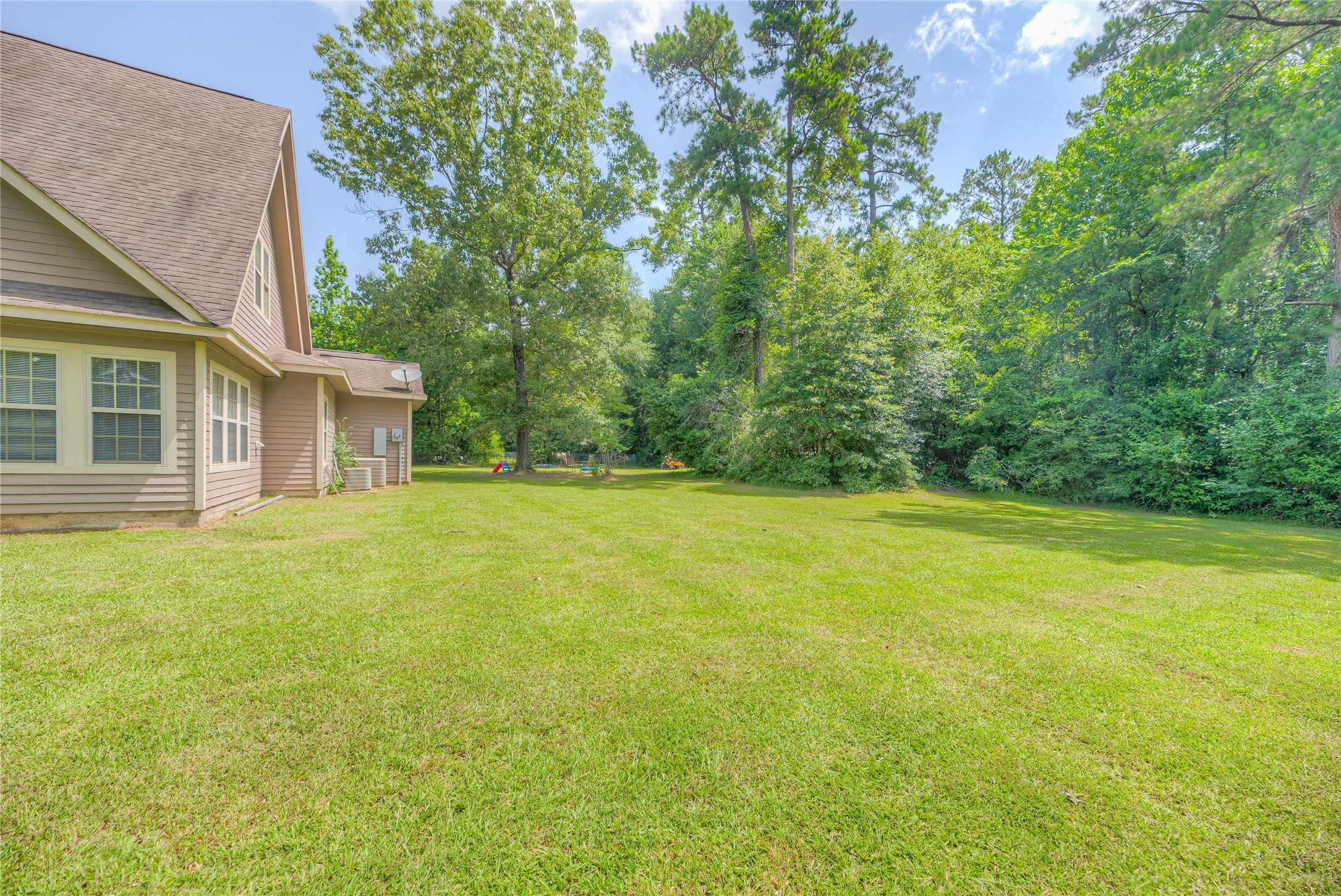 110 Happy Trails Road Coldspring, TX 77331 - Photo 32 of 49 Back yard- beautiful green grass to roam and play