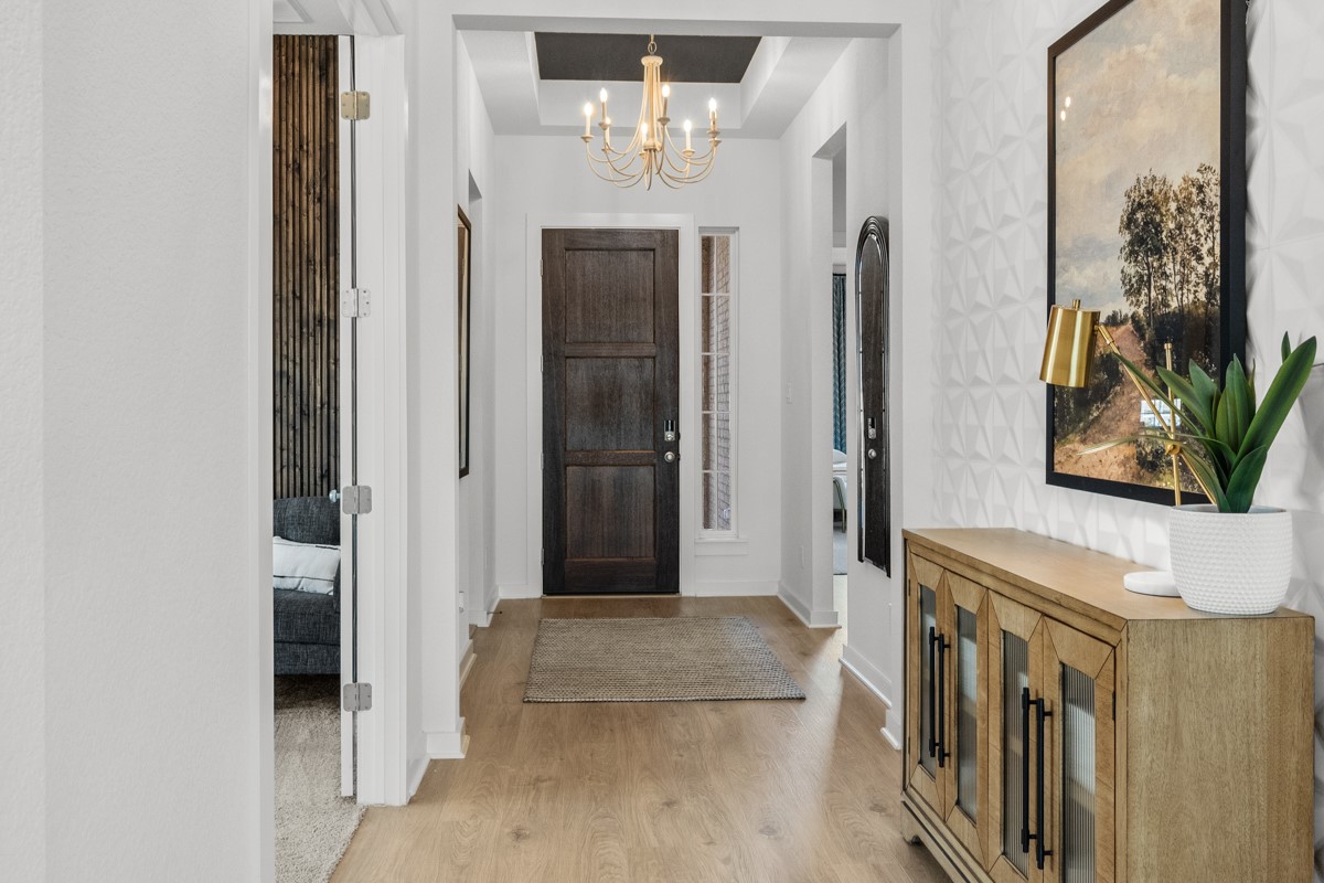 20400 Stelfox Street Manor, TX 78653 - Photo 2 of 37 Entryway with light wood-type flooring and a chandelier