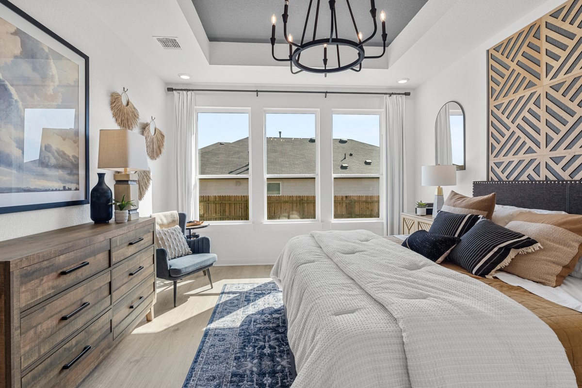 20400 Stelfox Street Manor, TX 78653 - Photo 19 of 37 Bedroom featuring light wood-style floors and a chandelier