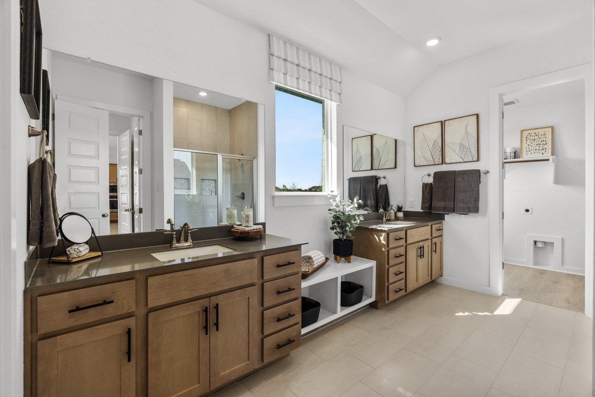 20400 Stelfox Street Manor, TX 78653 - Photo 22 of 37 Bathroom featuring a shower stall, two vanities, recessed lighting, vaulted ceiling, and light tile patterned flooring