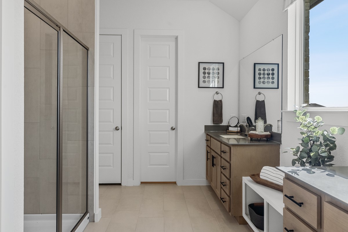 20400 Stelfox Street Manor, TX 78653 - Photo 24 of 37 Bathroom featuring vanity, a shower stall, and lofted ceiling