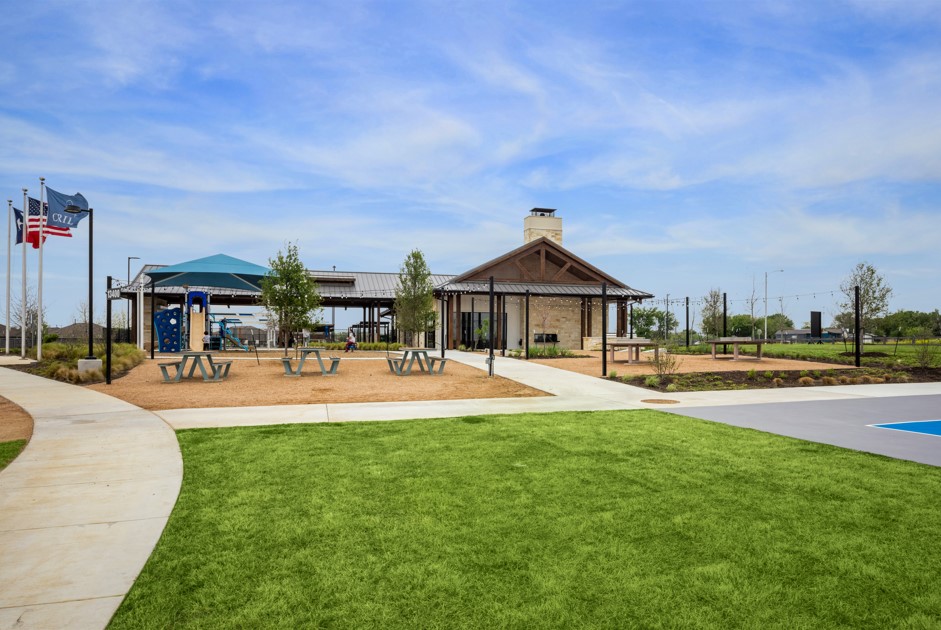 20400 Stelfox Street Manor, TX 78653 - Photo 29 of 37 View of community featuring a lawn and a patio area