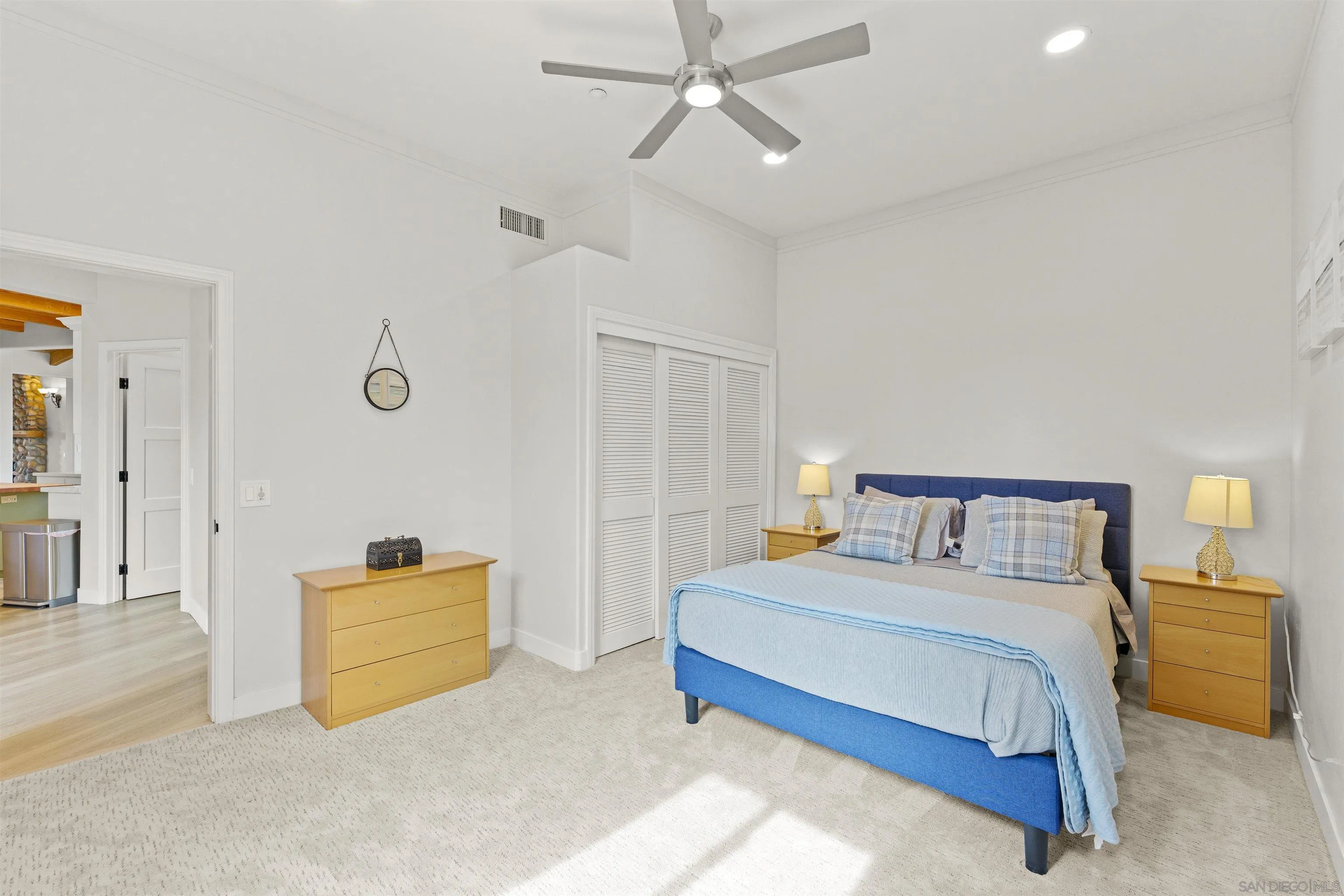 30659 Diaz Road Valley Center, CA 92082 - Photo 27 of 44 a spacious bedroom with a bed and a cabinets