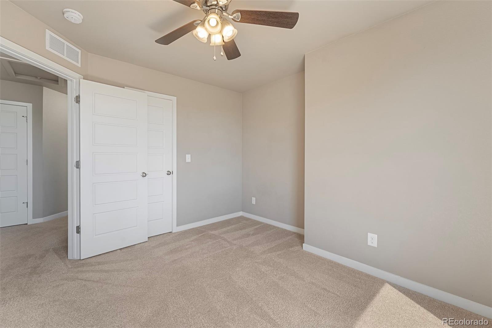 9528 Timberlake Loop Colorado Springs, CO 80927 - Photo 26 of 37 an empty room with a view of a chandelier fan